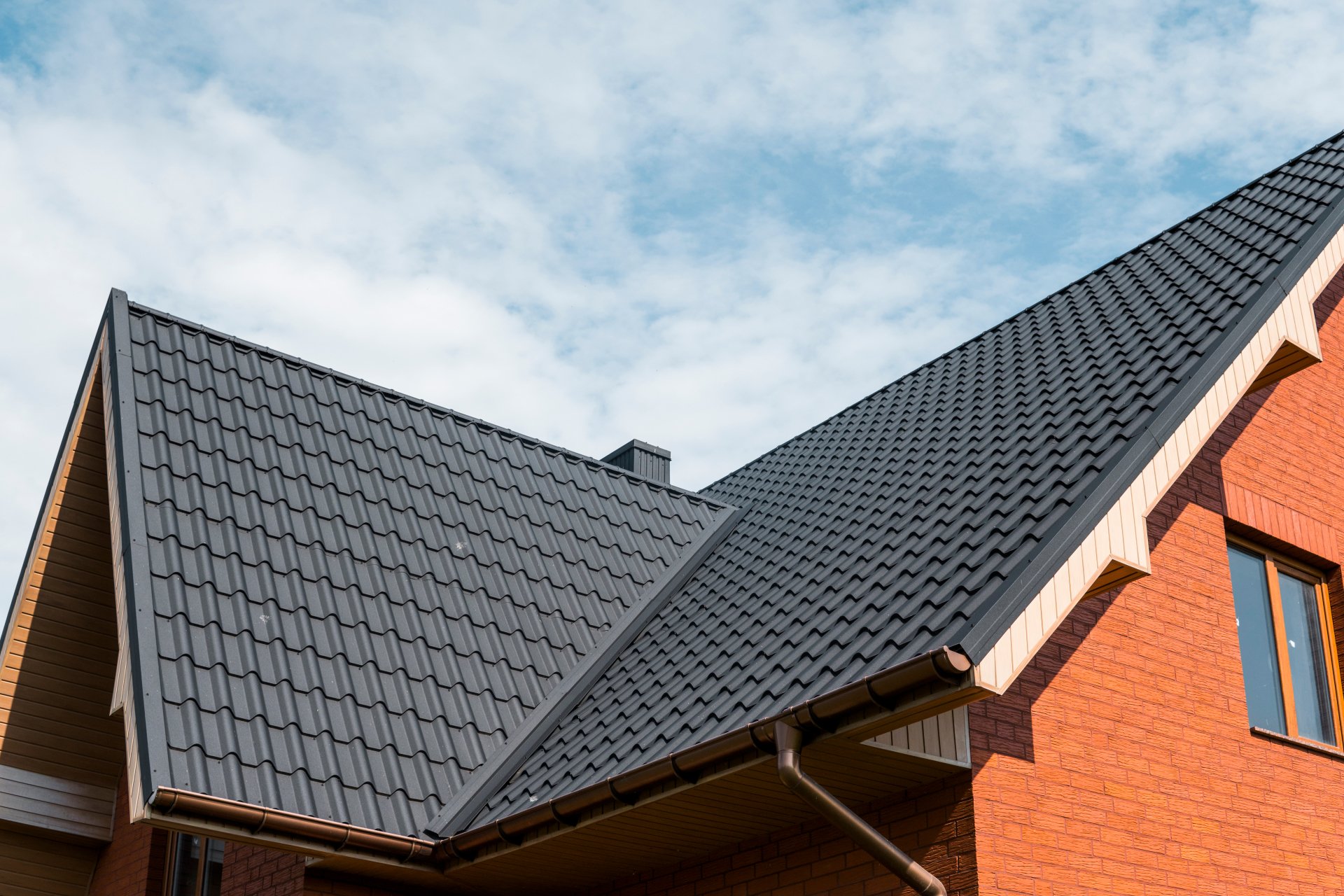 Canva+-+Modern+roof+covered+with+tile+effect+PVC+coated+brown+metal+roof+sheets.