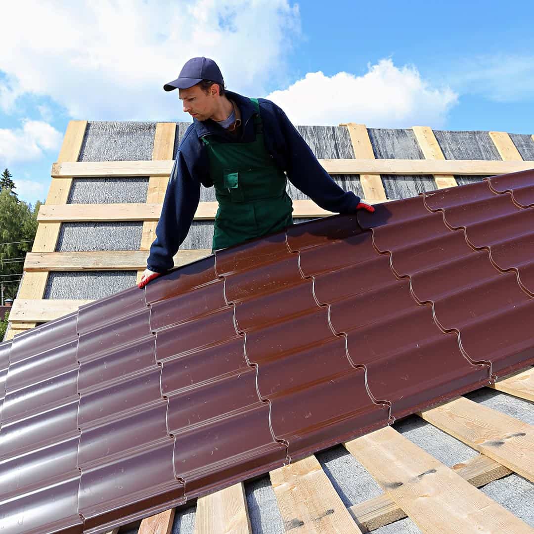 roofer installing a metal roof