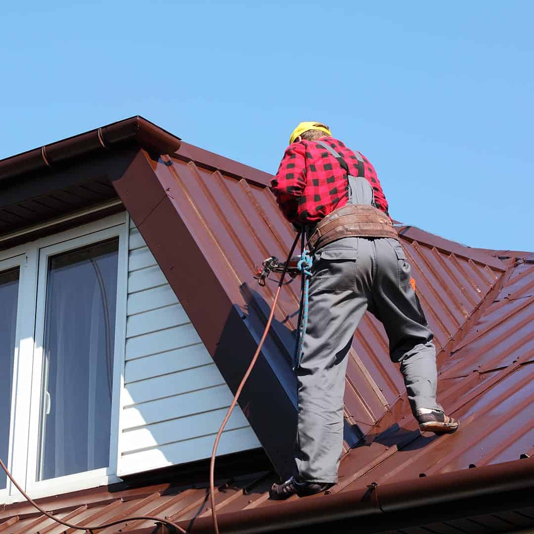 roofer repairing a metal roof
