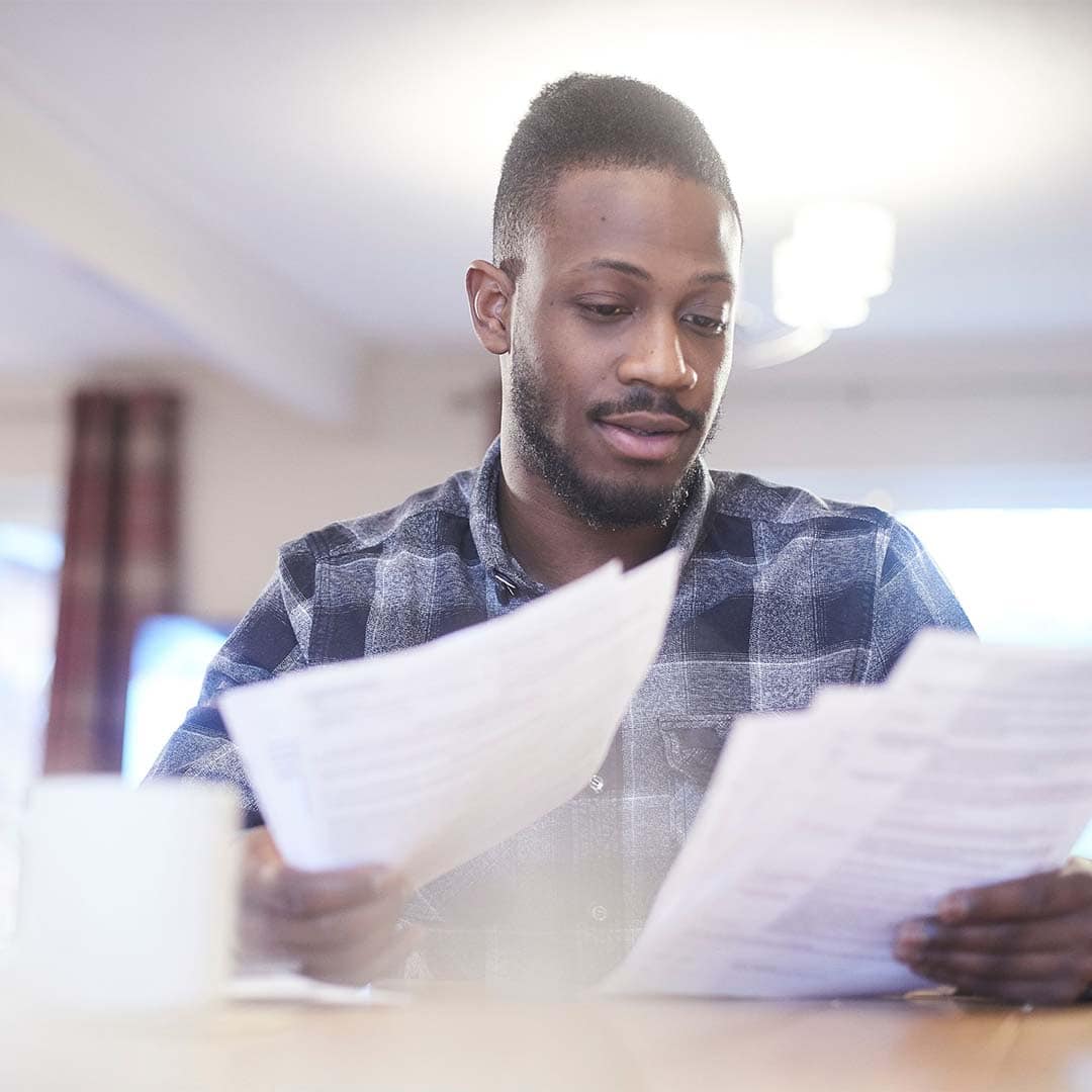 man looking at bills